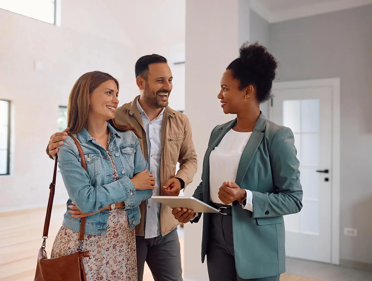 Real estate agent showing a young couple.